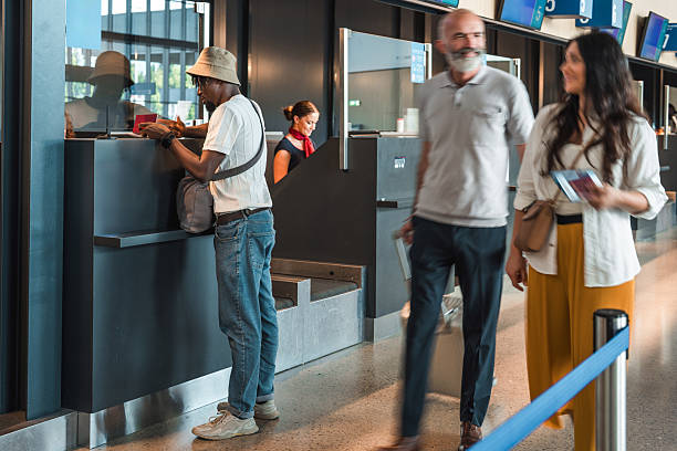 istock Passengers Queue at Airport Check-In Counter with Staff Assistance 2228383300