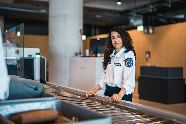 istock Young Hispanic Female Airport Security Worker at Baggage Screening Area Indoors 2228387059