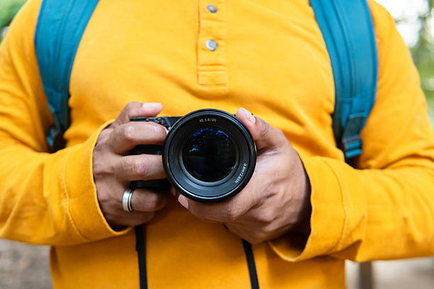 istock Photographer with mirrorless camera capturing nature's beauty during a forest hike, highlighting the bond between people and the environment 2228397076