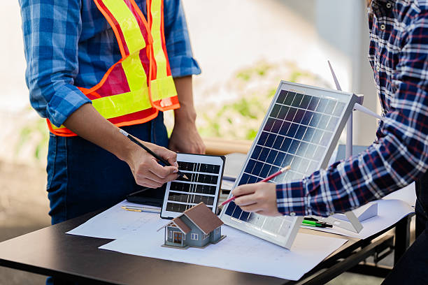 istock Engineers working on meeting blueprints to collaborate on projects with partners to create models and engineering tools on-site. 2228398541