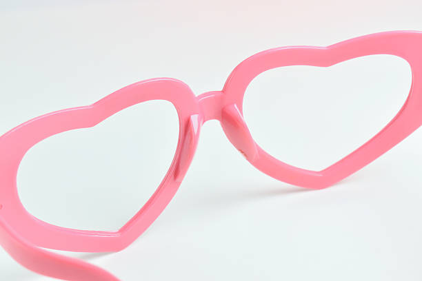 istock pink heart shape of glasses on white background 2228399070