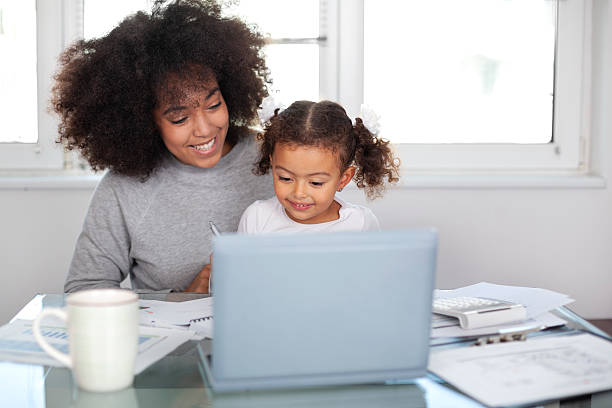 istock Young mother working and spending time with her daughter 2228399509
