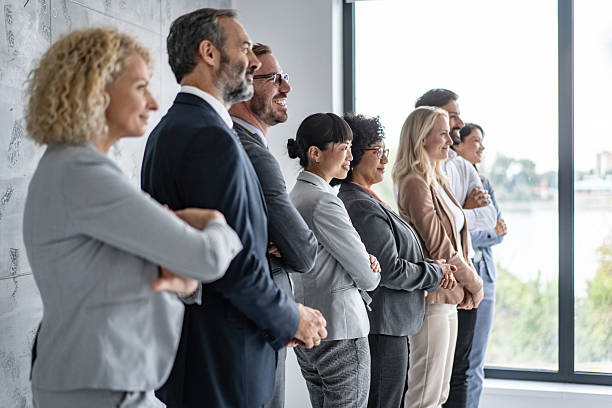 istock Diverse Professionals Standing in Formation by a Window 2228399951