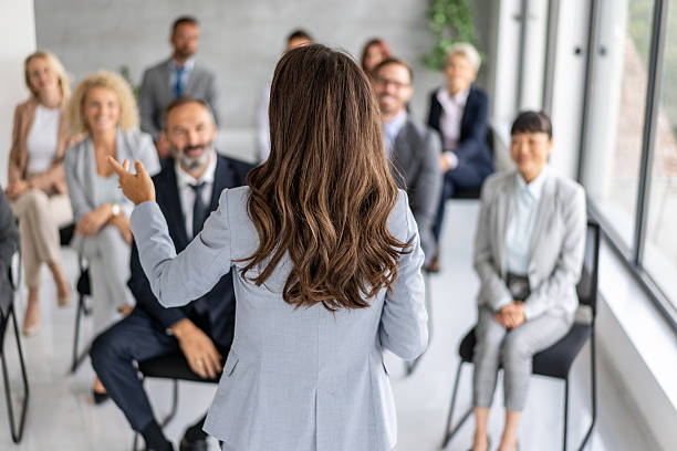 istock Audience Reaction to Professional Speaker in Modern Setting 2228399972