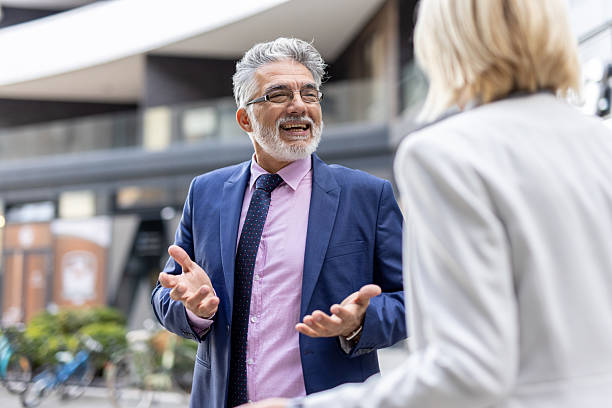 istock Businessman explaining concepts enthusiastically outdoors 2228400072