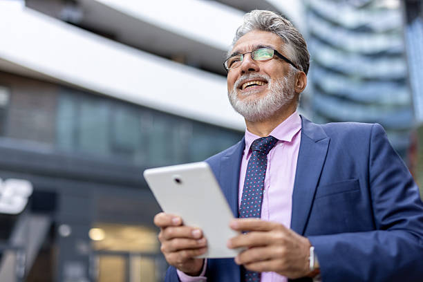 istock Smiling female executive holding tablet in a plaza. 2228400087