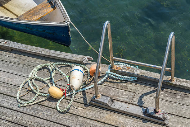 part of old concrete sea berth or pier with car tires for mooring boats and yachts and calm sea water surface