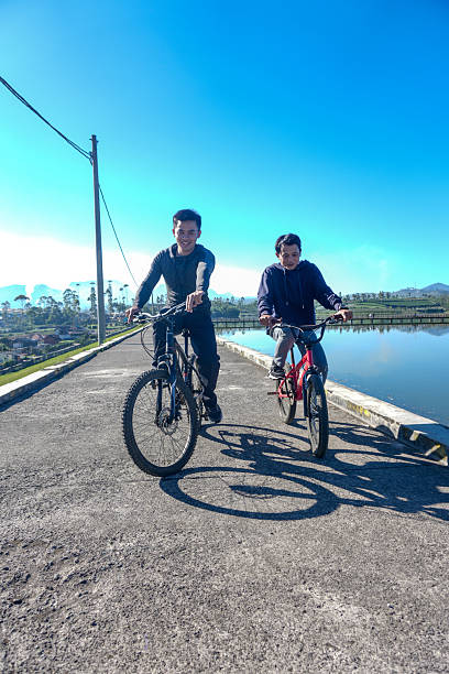 istock Friends Cycling On a Lakeside 2228402421
