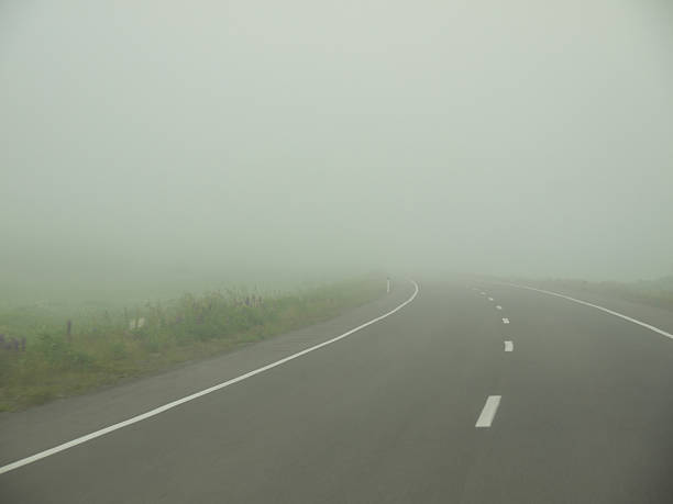 istock Driving by foggy highway in low visibility 2228408455