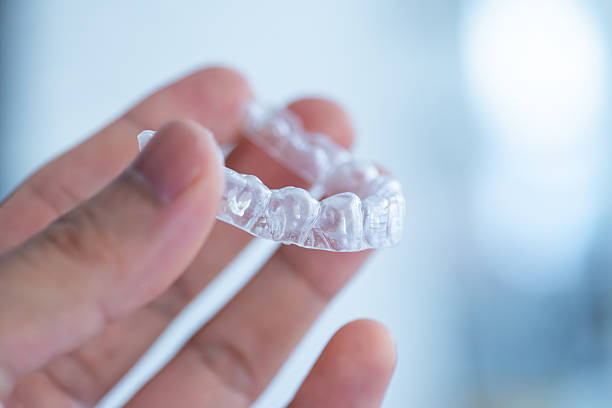 istock clear aligners device in the mouth on a white background. (invisalign) 2228414008