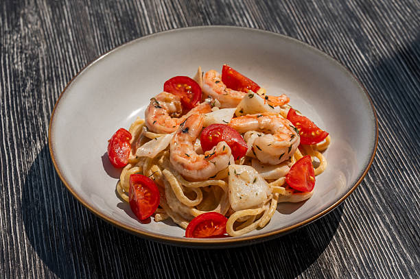 istock Pasta with shrimp and tomatoes. 2228415602