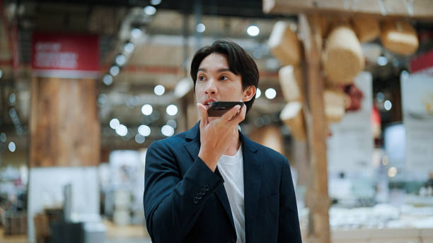 istock Young Asian man asking for information from AI assistant while looking for items in a shopping mall. 2228418771