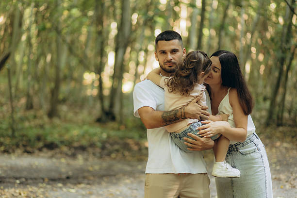 istock Happy Family Embracing in a Peaceful Forested Setting 2228420697