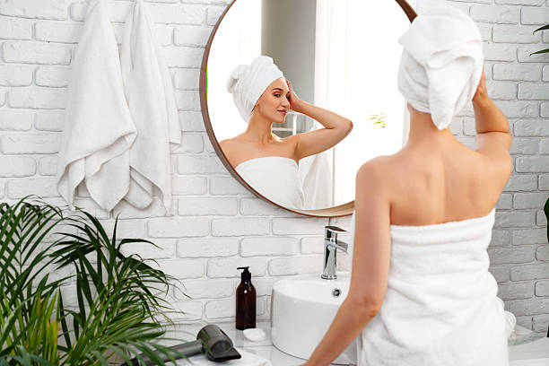 istock Woman preparing for her day in a modern bathroom with elegant decor and natural elements 2228423600