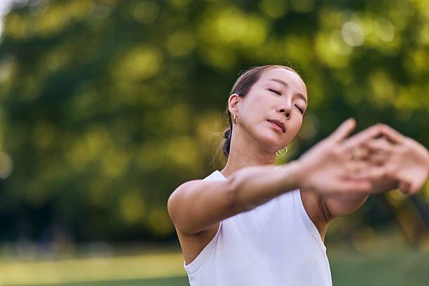 Woman Meditating Outdoors in Relaxing Natural Garden Setting