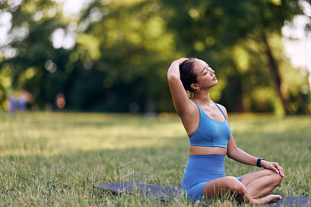 istock Woman Practicing Yoga Outdoors in Nature While Wearing Athletic Clothing 2228425461