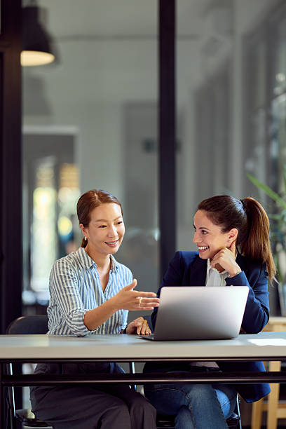 istock Two Women Collaborating on a Laptop in Modern Office Environment 2228426400