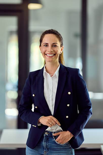istock Confident Young Businesswoman Smiling in Modern Office Setting 2228426436