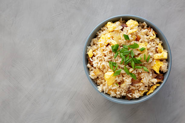 istock Homemade Fried Rice with Bacon and Egg in a Bowl, top view. Flat lay, overhead, from above. Copy space. 2228426890
