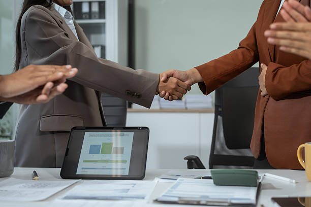 istock Business professionals shake hands at the table to conclude a successful agreement or collaboration. Cooperation, trust, investment, mutual success, which is the closing of a strategic business deal 2228429843