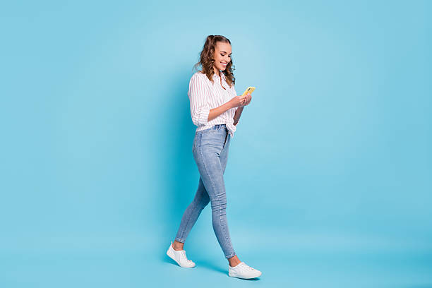 istock Full length body size profile side view of nice focused cheerful girl using device walking isolated on vivid blue color background 2228432323
