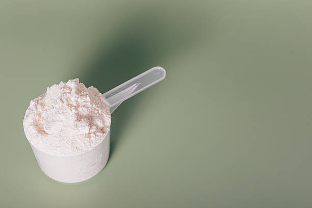 istock Scoop of powder is sitting on a green surface 2228434383