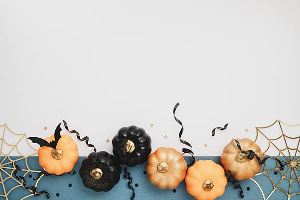 istock Halloween party border from pumpkins, bats, spider web on dark blue background top view. 2228435060