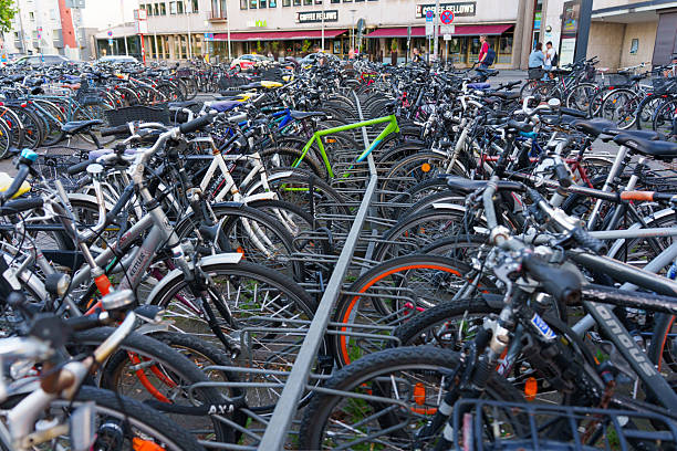 Heidelberg, Germany - June 21, 2025: Densely packed bicycle parking lot showing various bike models in an urban area during daylight.