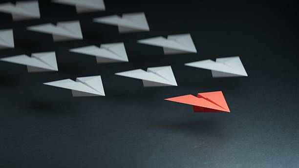 istock Different business concept.new ideas. paper art style. creative idea.Leaderplane concept, black leader plane leading white planes.3D rendering on black background. 2228435589