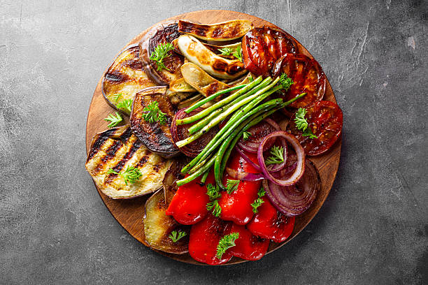 istock grilled vegetables - eggplant, pepper, onion, tomato and beans on grey background 2228436822