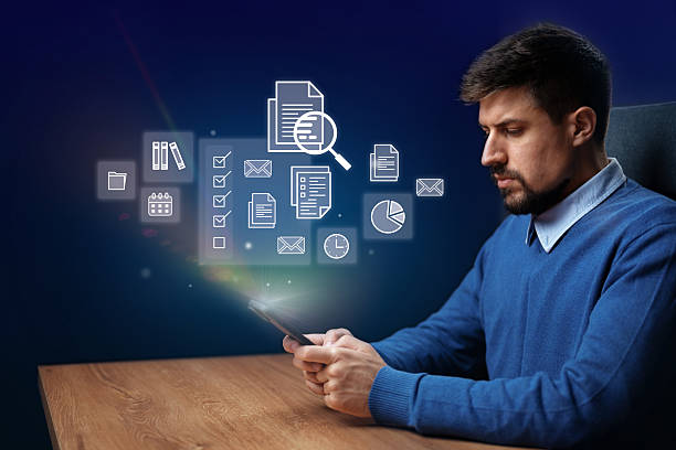 istock Professional man engaged in digital task on smartphone while working at desk with connected icons in background 2228438844