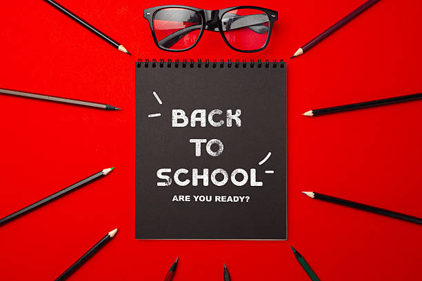 istock Creative back to school setup with glasses and stationery on a vibrant red background promoting readiness for the new academic year 2228438879