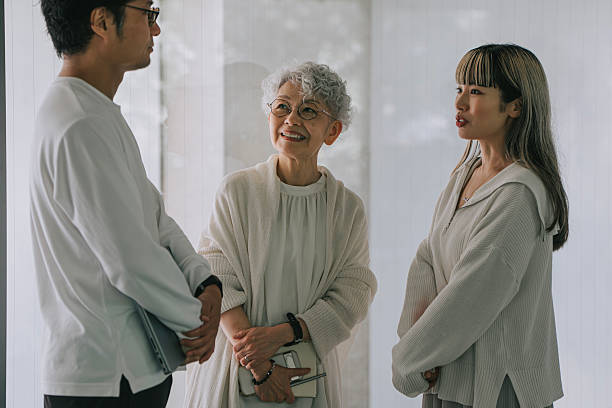 istock Intergenerational Japanese Group Engaged in Conversation in Bright Minimalist Setting 2228440097