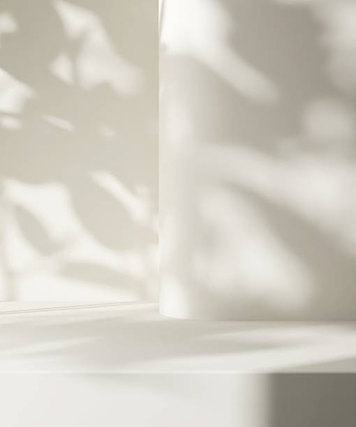 istock Modern, minimal empty cream counter table in dappled sunlight, shadow on smooth curved wall for luxury, elegant fashion, beauty, cosmetic, skincare, body care product display background 3D 2228441820