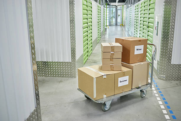 istock Stack of Cardboard Boxes on Cart in Self Storage Facility Corridor 2228442807