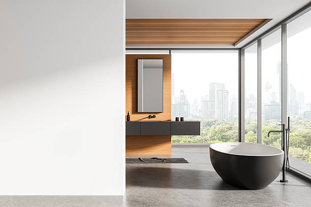 istock Modern bathroom interior with white blank wall and bathtub overlooking city skyline, ideal for poster mockup or design template presentation concept. 3D Rendering 2228443410
