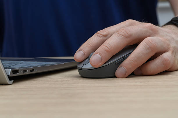 istock Close-up of a computer mouse, a man's hand is resting on our computer mouse. 2228445593