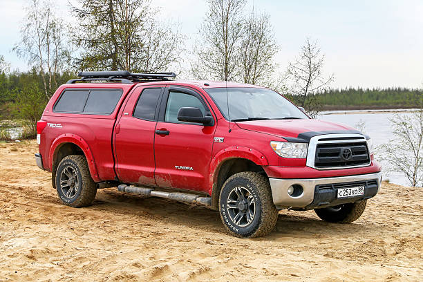 Novyy Urengoy, Russia - June 12, 2025: Red pickup truck Toyota Tundra (XK50) at the countryside.