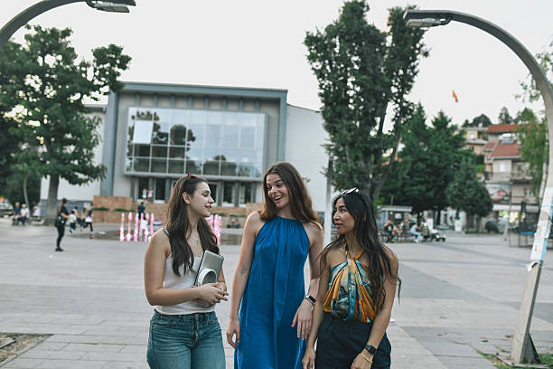 istock Trendy Group Of Three Women Chatting Happily While Exploring Bustling City Square Together 2228450488
