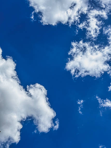 istock Bright Blue Sky with Fluffy White Cumulus Clouds 2228450733