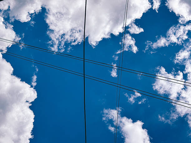 istock Abstract View of Power Lines and a Cloudy Blue Sky 2228450739