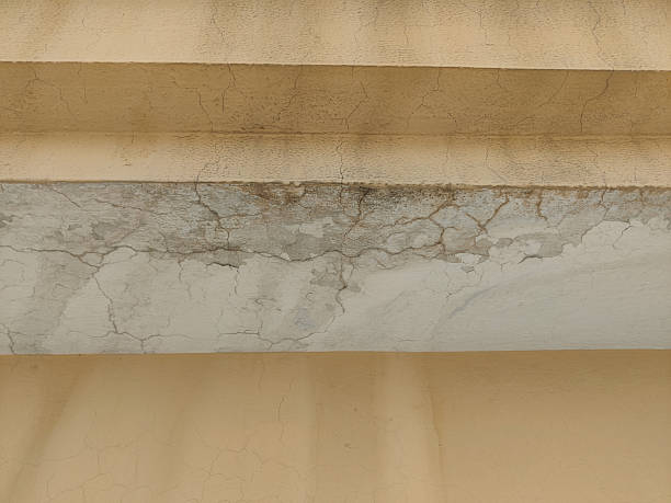 istock Close up showing cracked and peeling paint on an interior wall surface area 2228451542