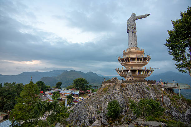 Visitors at Jesus Blessing statue in Buntu Burake, Tana Toraja Regency, South Sulawesi, Indonesia. This tallest statue of Jesus Christ stands atop Buntu Burake hill, approximately 1,700 meters above sea level.