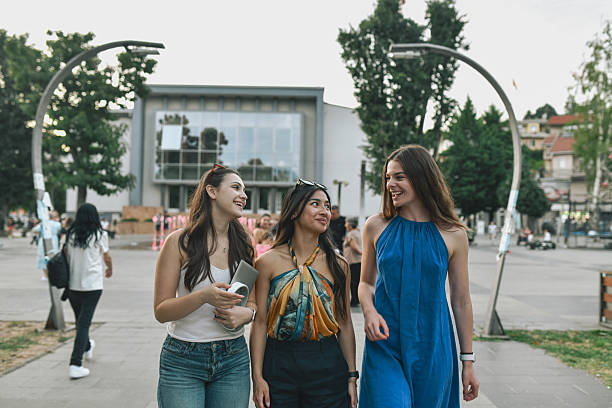 istock Close Female Friends Walking Through Urban Square While Enjoying Meaningful Conversation 2228454379