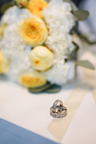 istock Wedding engraved gold wedding rings and wedding bouquet. Wedding ceremony. 2228455402