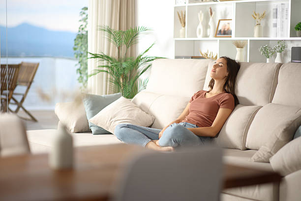 istock Relaxed woman sitting on comfortable couch enjoying free time 2228456354