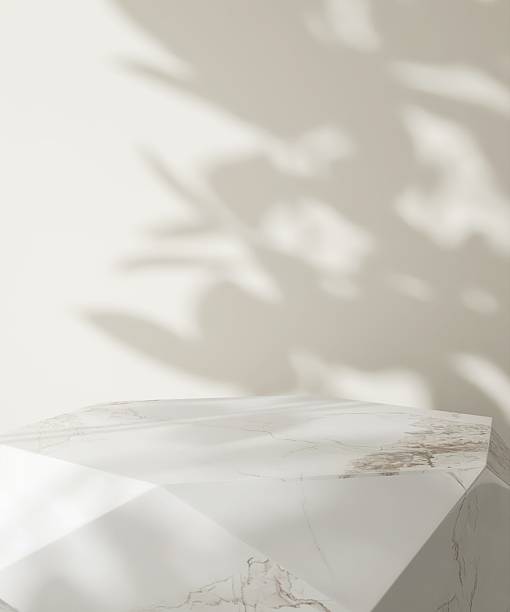 istock White modern, minimal marble dodecahedron podium table in dappled sunlight, leaf shadow on cream wall for luxury, elegant fashion, beauty, cosmetic, skincare, body care product display background 3D 2228456999