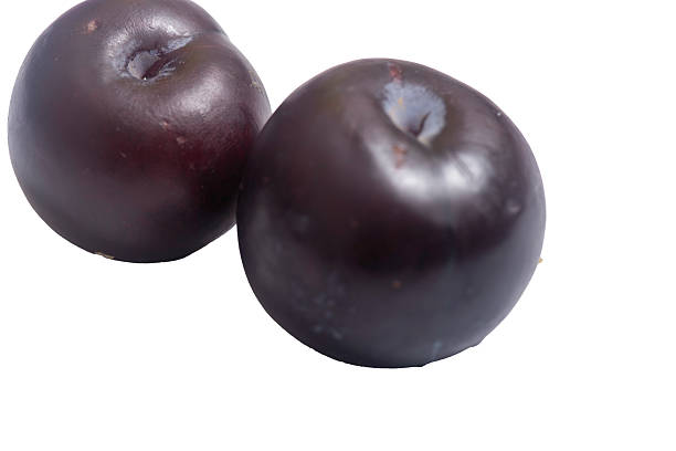 istock Plums with green leaves on a white background ** Note: Slight graininess, best at smaller sizes 2228457919