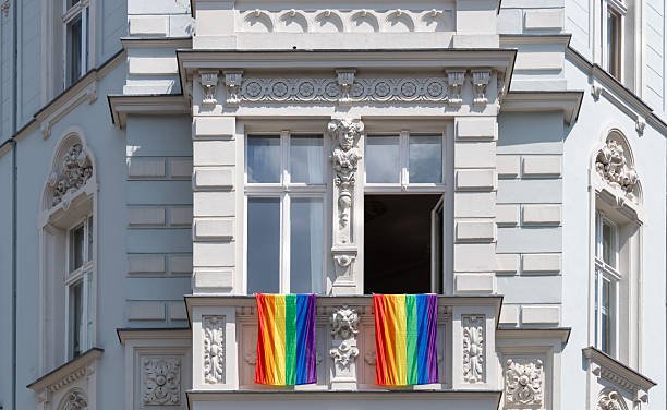 istock Rainbow flags on the windows of a residential building 2228460853