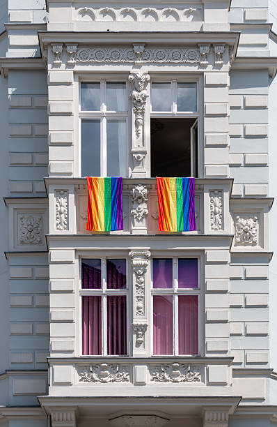 istock Rainbow flags on the windows of a residential building 2228460937